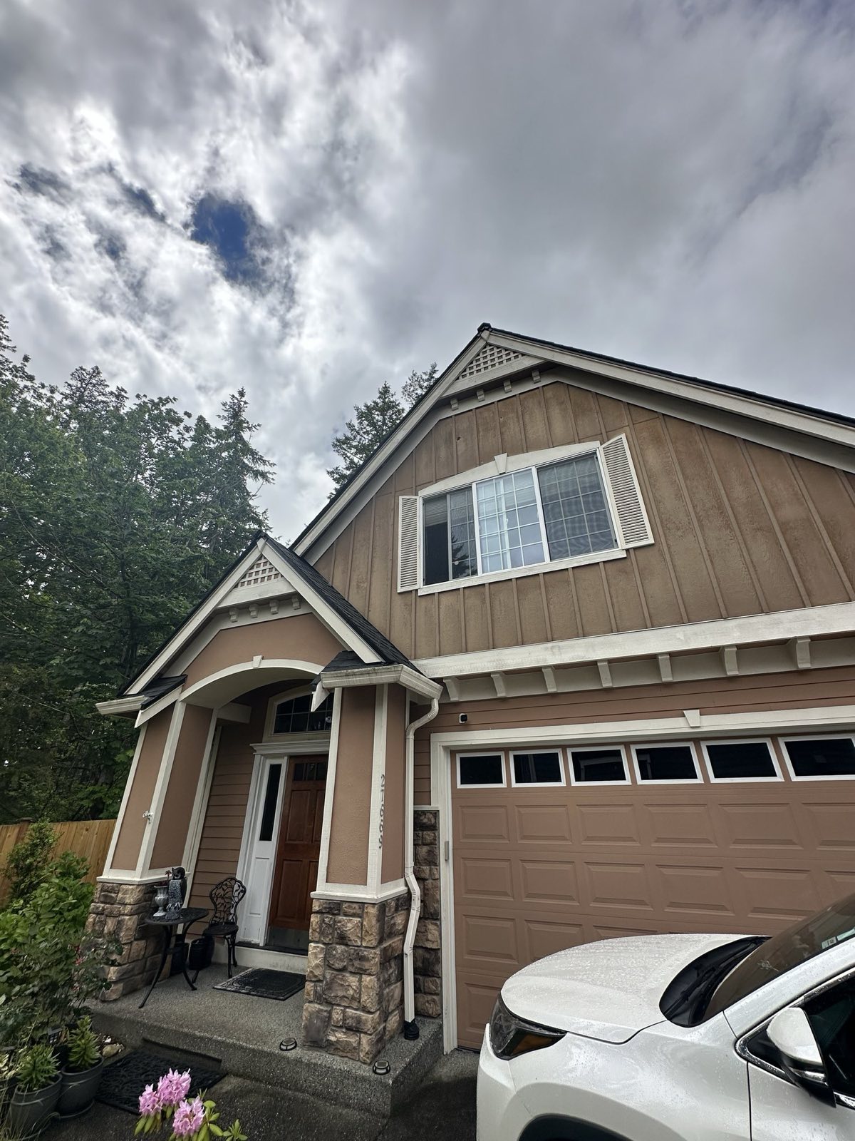 Two-story craftsman home with a stone-columned entry porch